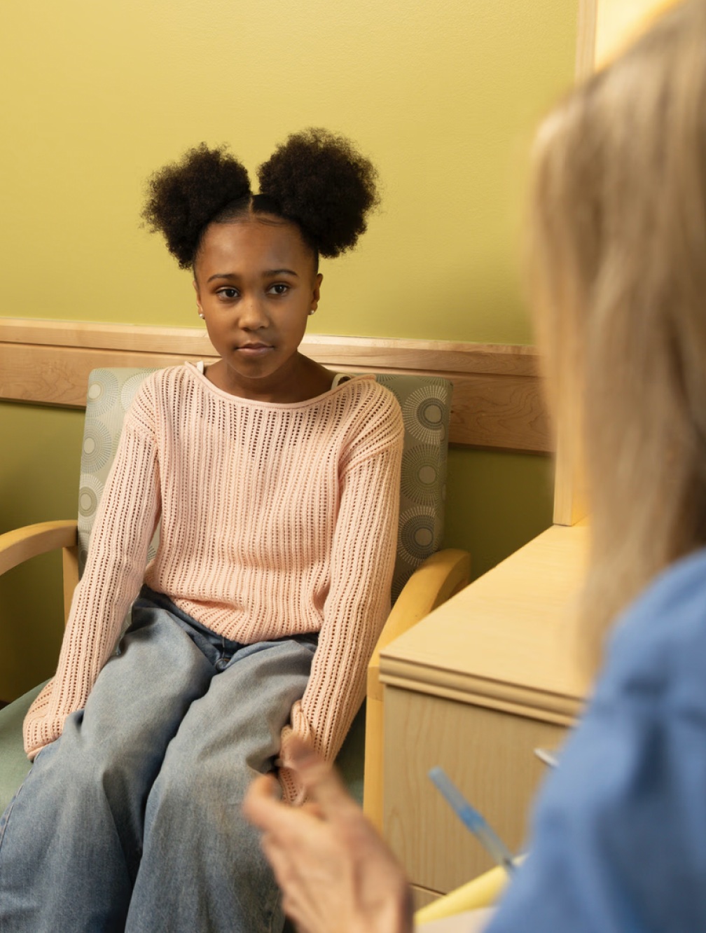 Child sitting with a care provider