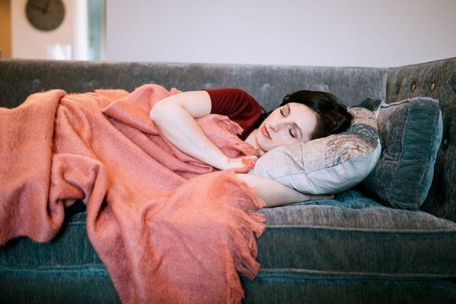 Person who wakes up with anxiety is sleeping on the couch.
