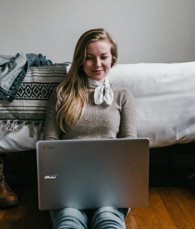 A young woman typing on laptop