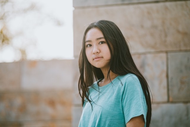 young female looks seriously at camera 